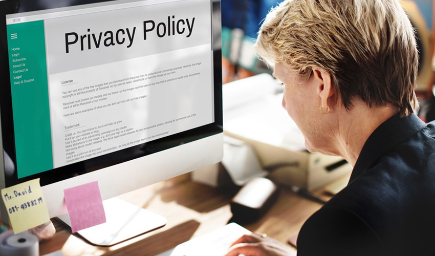 woman sitting infront of a monitor saying privacy policy