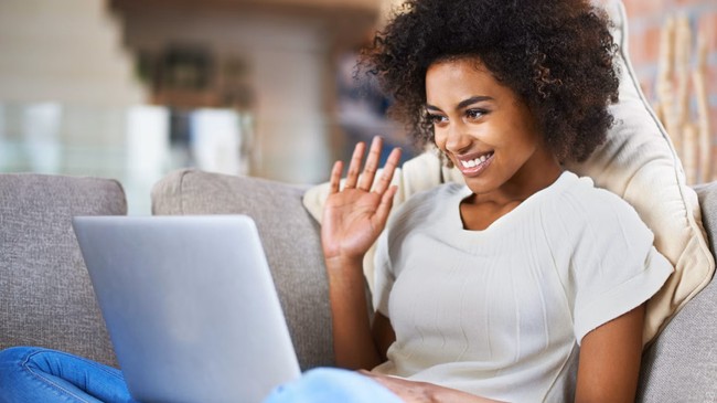 woman sitting on a couch, smiling
